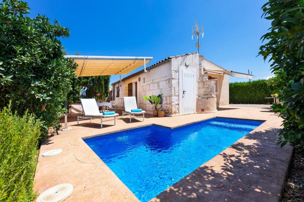 a swimming pool in a yard with a house at Biniaco in Muro