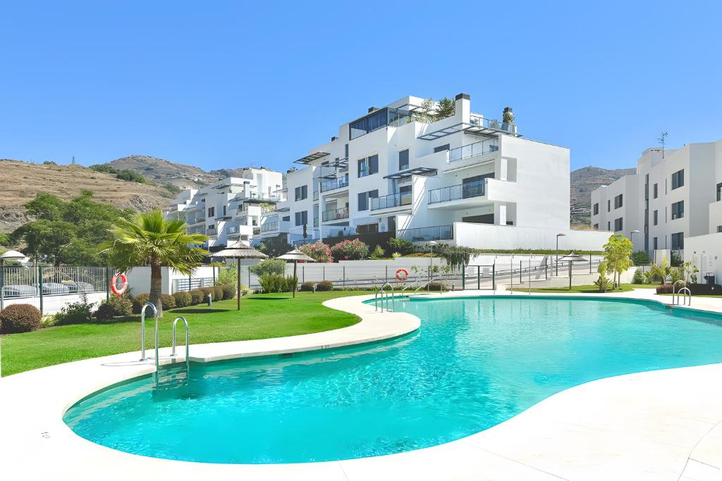 a large swimming pool in front of a building at Beach Apartment with Pool, Terrace in Taramay