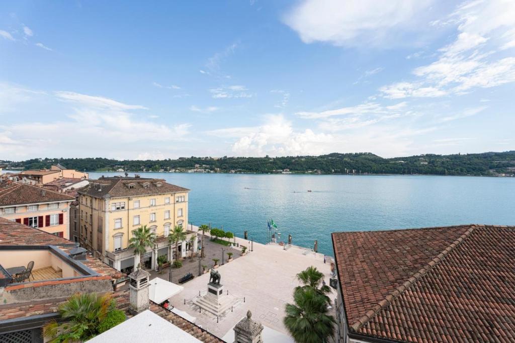 a view of a large body of water with buildings at Aa Imbarcadero apartments in Salò