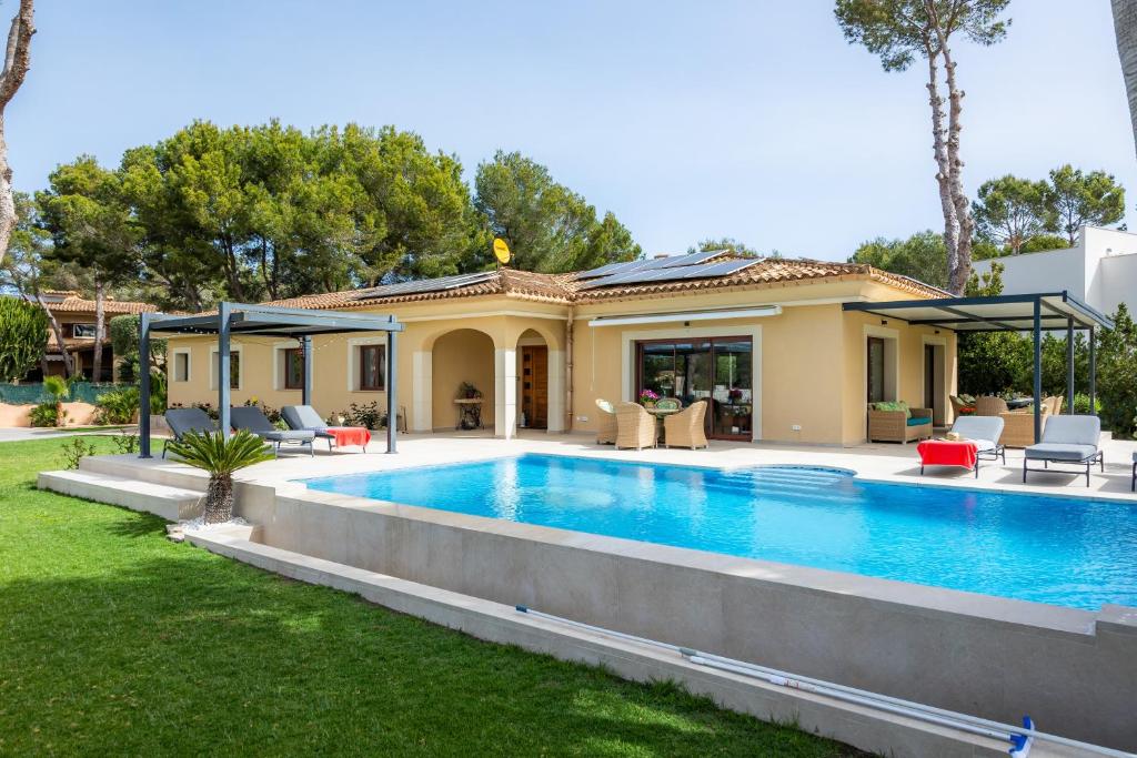a house with a swimming pool in a yard at Luxurious villa Sol de Mallorca in Sol de Mallorca