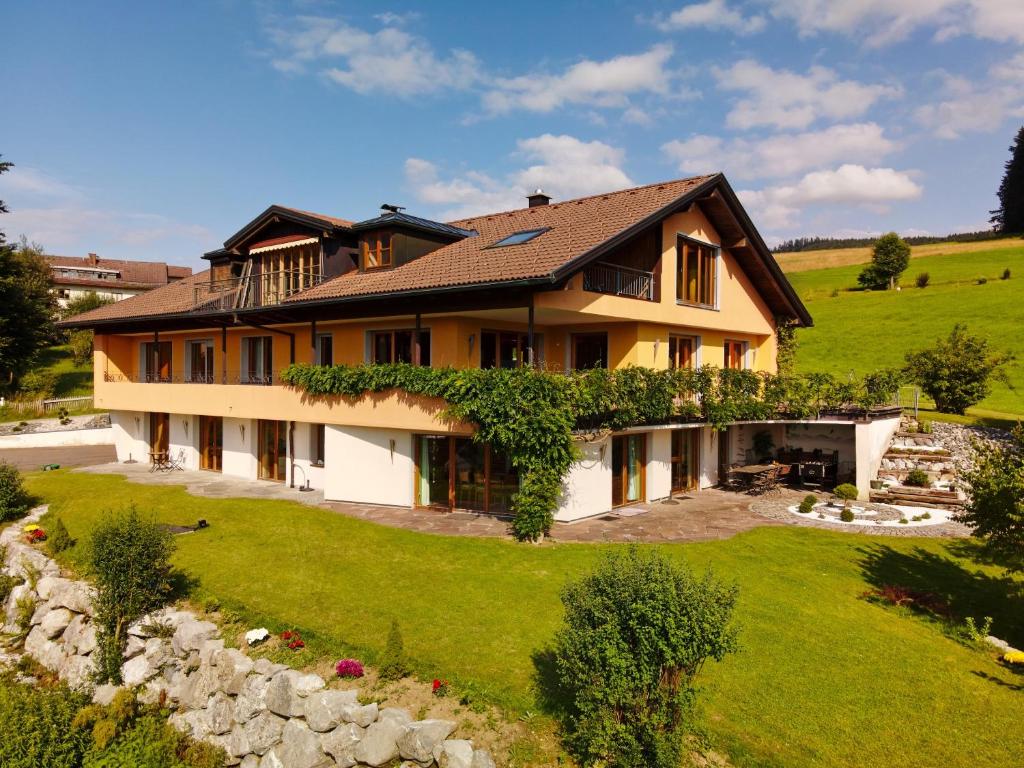 a house on a hill with a green yard at Lichtblick in Weiler-Simmerberg