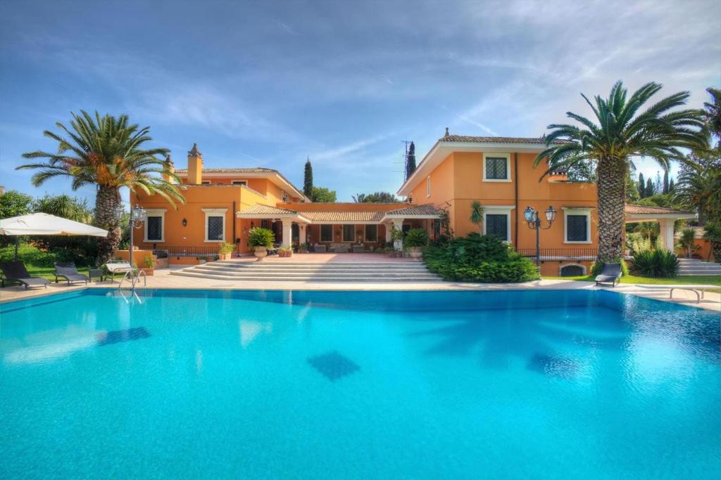 a large swimming pool in front of a house at Le dimore di Elia in Lecce