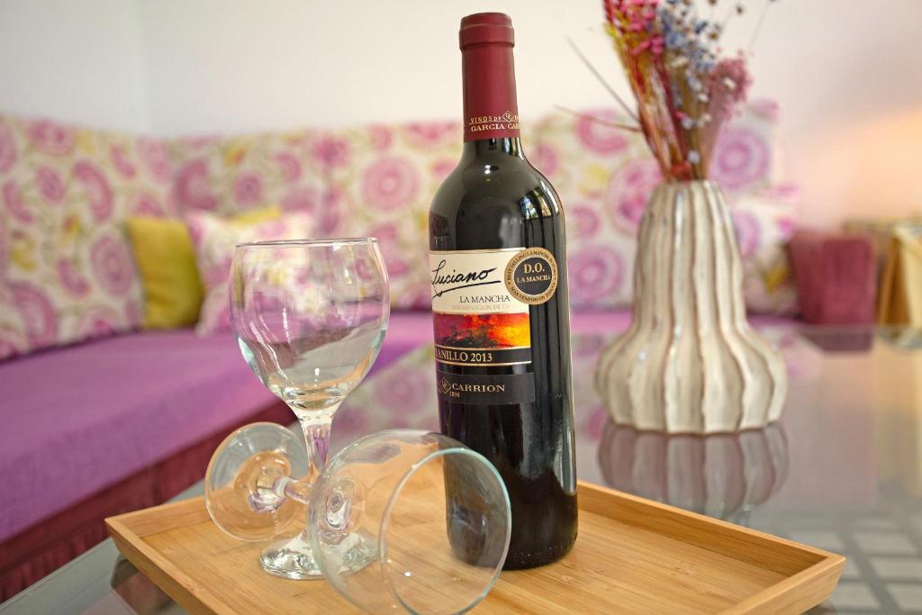 a bottle of wine and glasses on a table at Apartamento Danoe 1 in Mogán