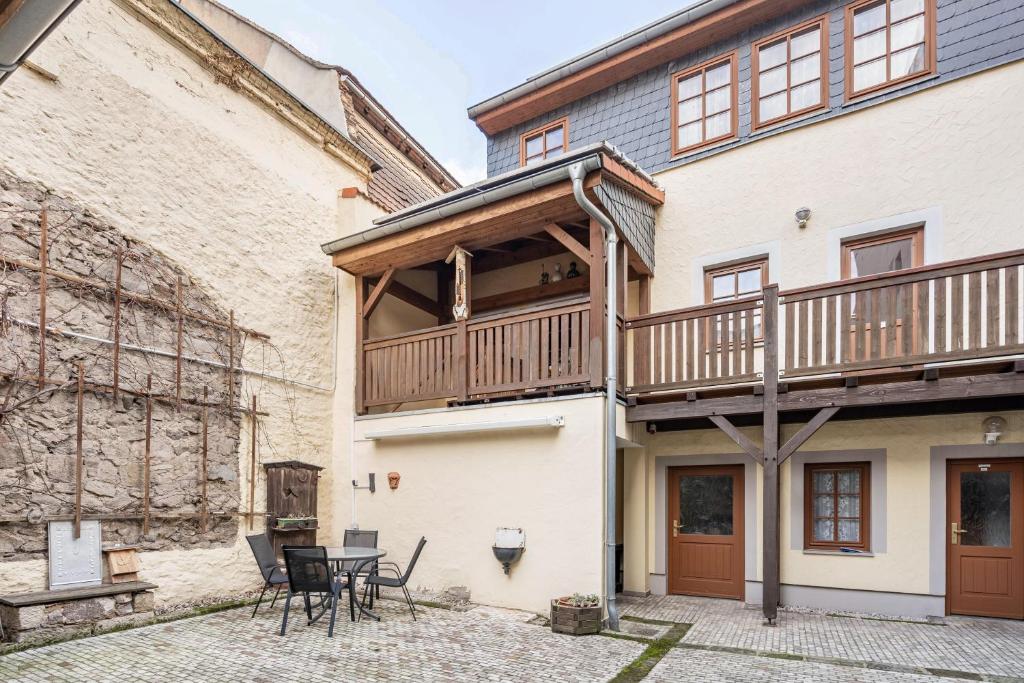 a house with a deck on the side of it at Pension Ufert in Meißen
