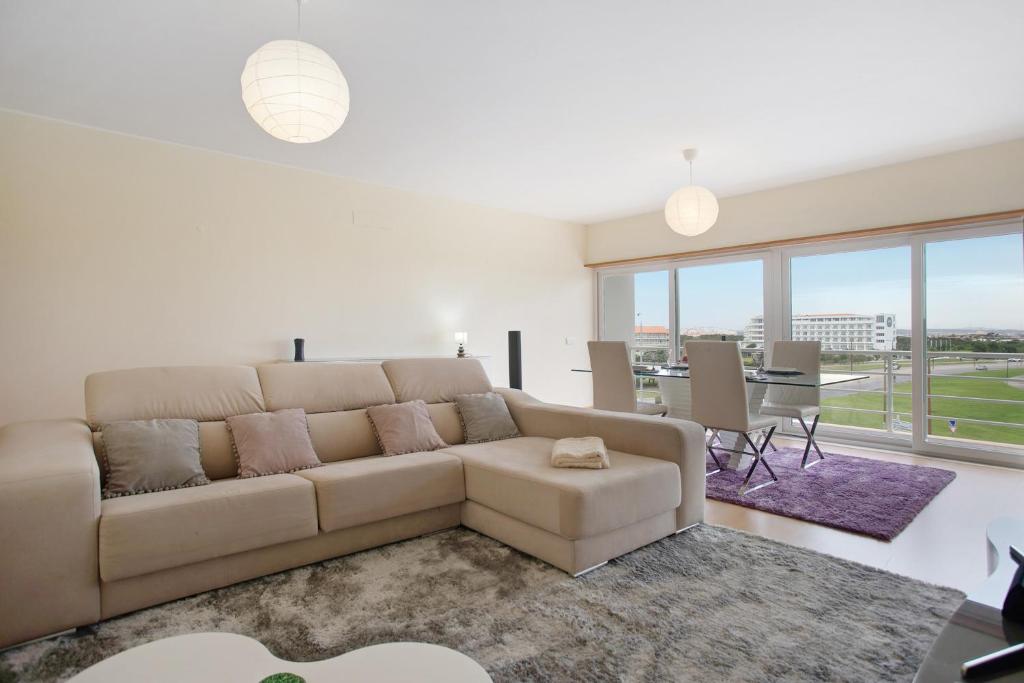 a living room with a couch and a table at A O - Apart Passarelle in Peniche