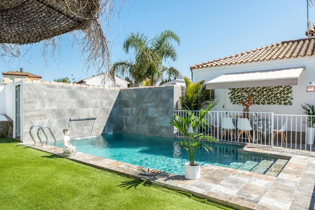 a swimming pool in the backyard of a house at Casa Mirajanda in Vejer de la Frontera