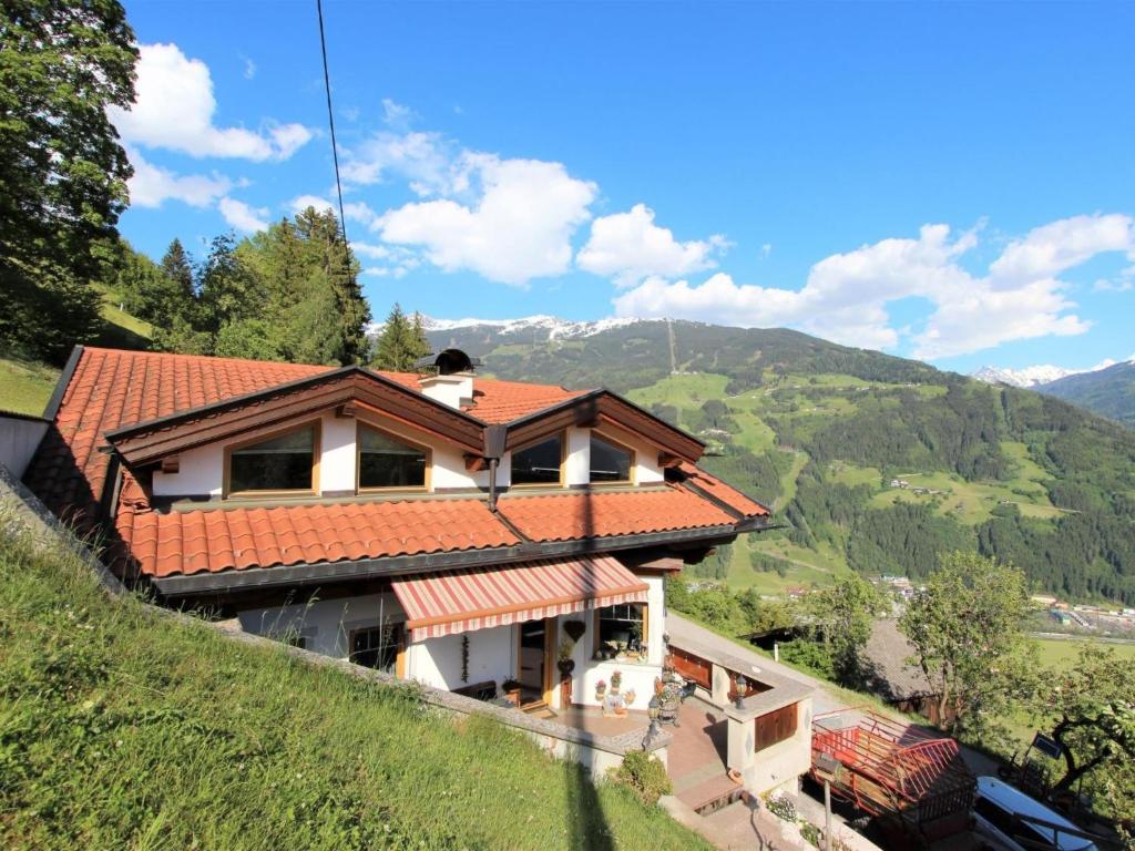 a house with a red roof on a hill at Apartment Melissa in Zellberg