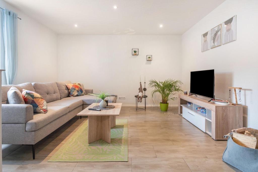 a living room with a couch and a tv at Ferienhaus Hedrich in Gülzow