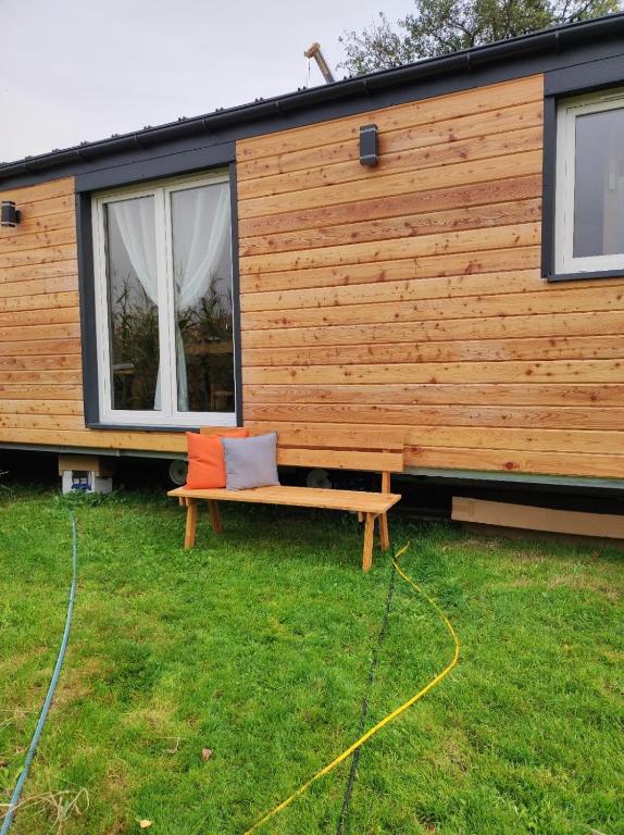 a house with a bench in front of it at Unser Großer - Tiny House in Mayrhof