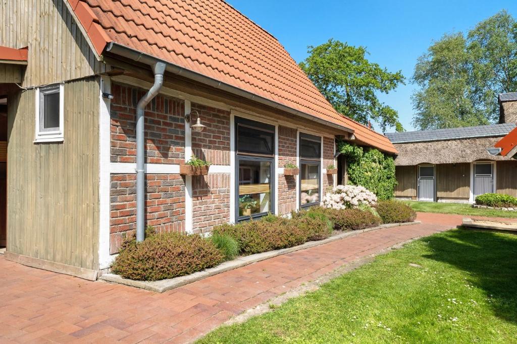 a brick house with an orange roof at Haus Schöneck in Otterndorf