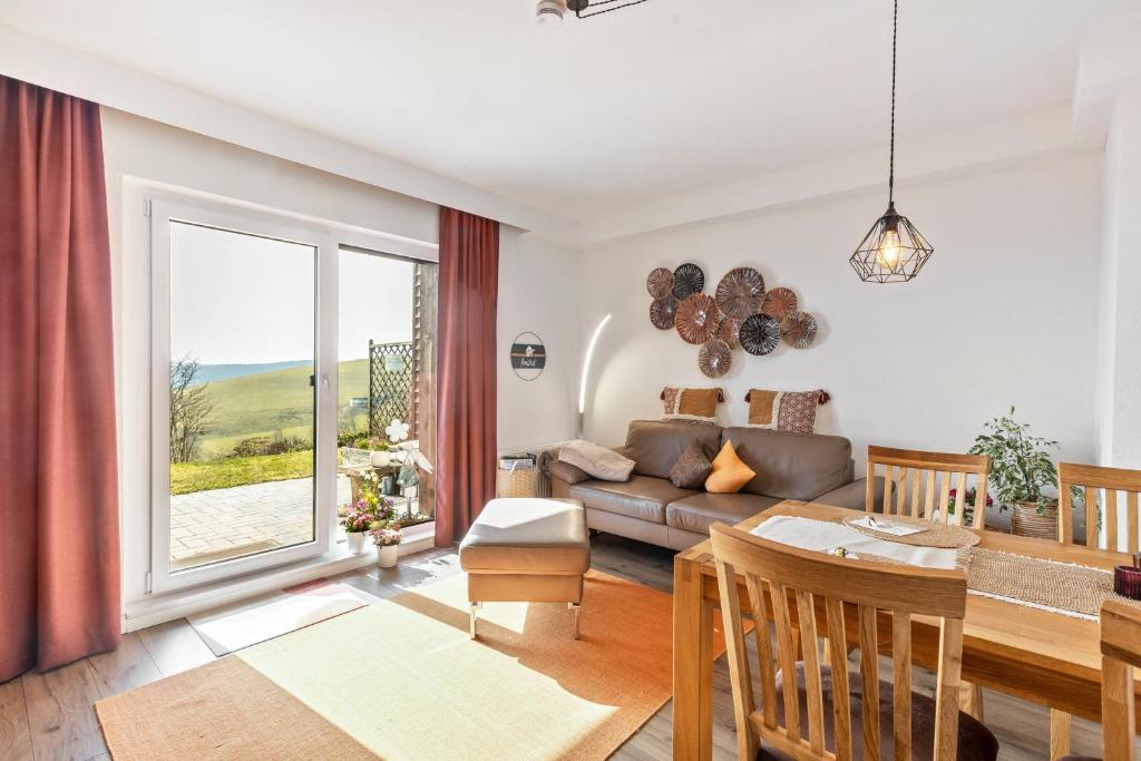 a living room with a couch and a table at Fewo Auszeit zum Anspel in Medebach
