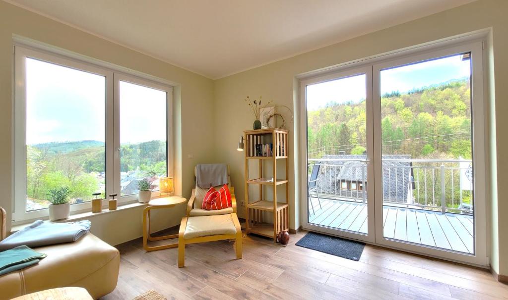 a living room with a large sliding glass door at Gittas Paradiesperle in Niederdreisbach