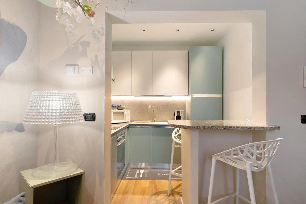 a small kitchen with a counter and a table at Soleluna in Vado Ligure