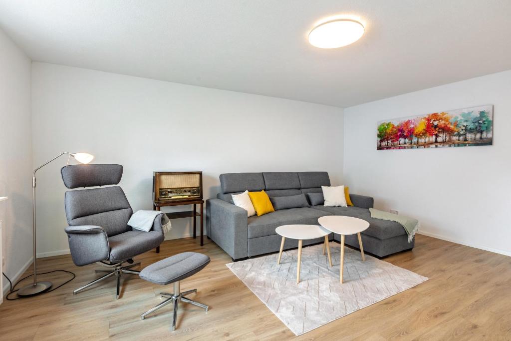a living room with a couch and a table and chairs at Ferienwohnung K5 in Wehr