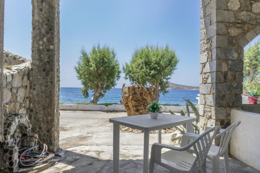a table and chairs on a patio with a view of the ocean at Syrios Suites No 2 in Kalymnos