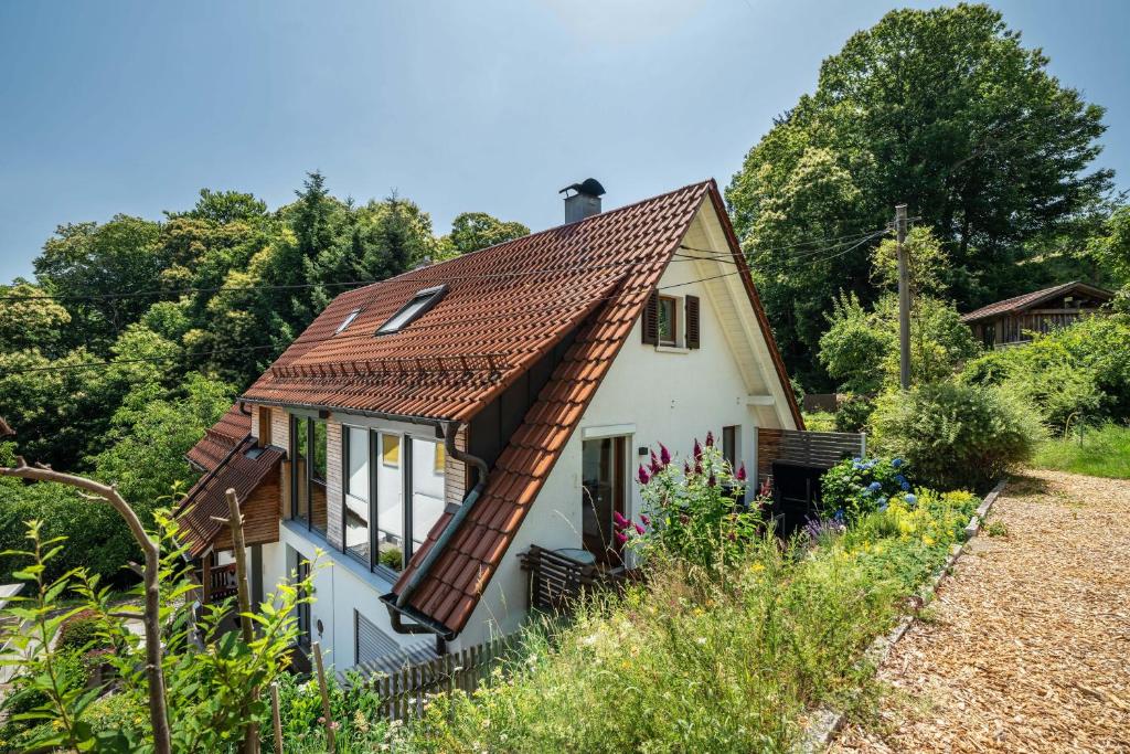 a small white house with a copper roof at Ferienwohnung s'Raubers in Bühlertal