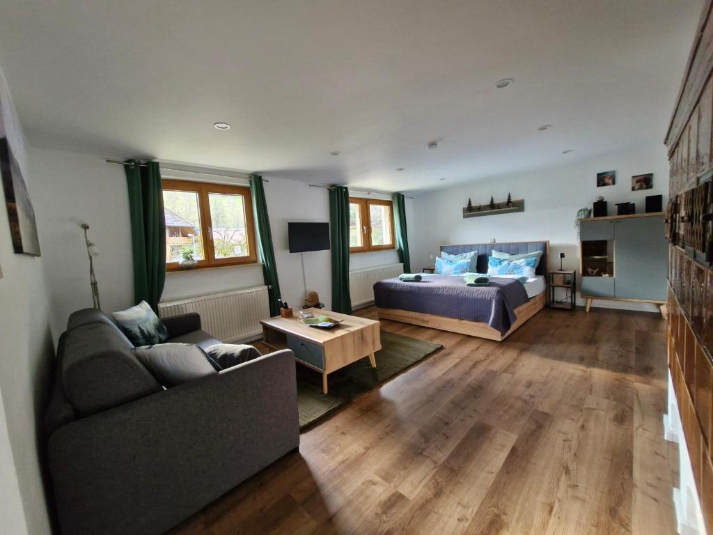 a living room with a couch and a bed at Ferienwohnung Vordere Halde in Elzach