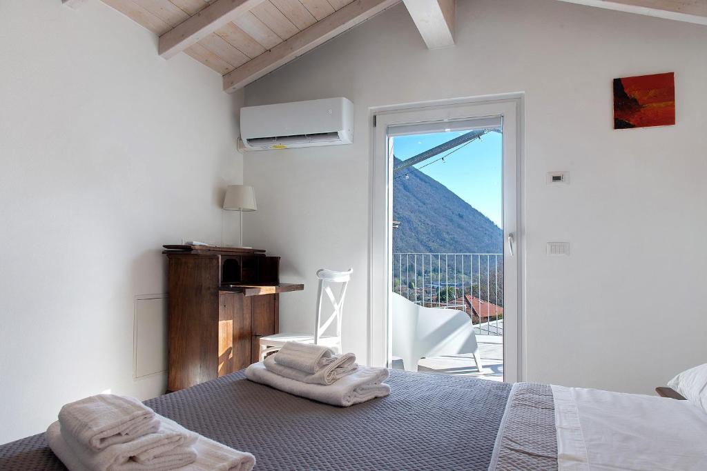 a bedroom with a bed with towels on it at Residenza La Fonte Dependance in Laveno-Mombello