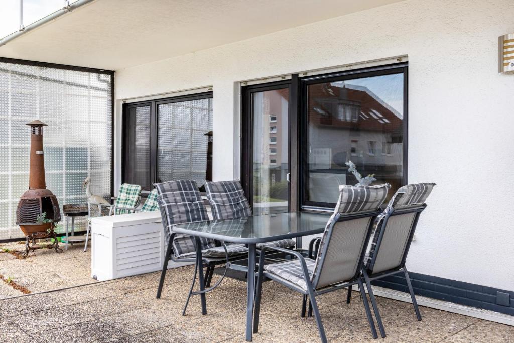 a glass table and chairs on a patio at Ferienwohnung Sonnenschein in Bad Hersfeld