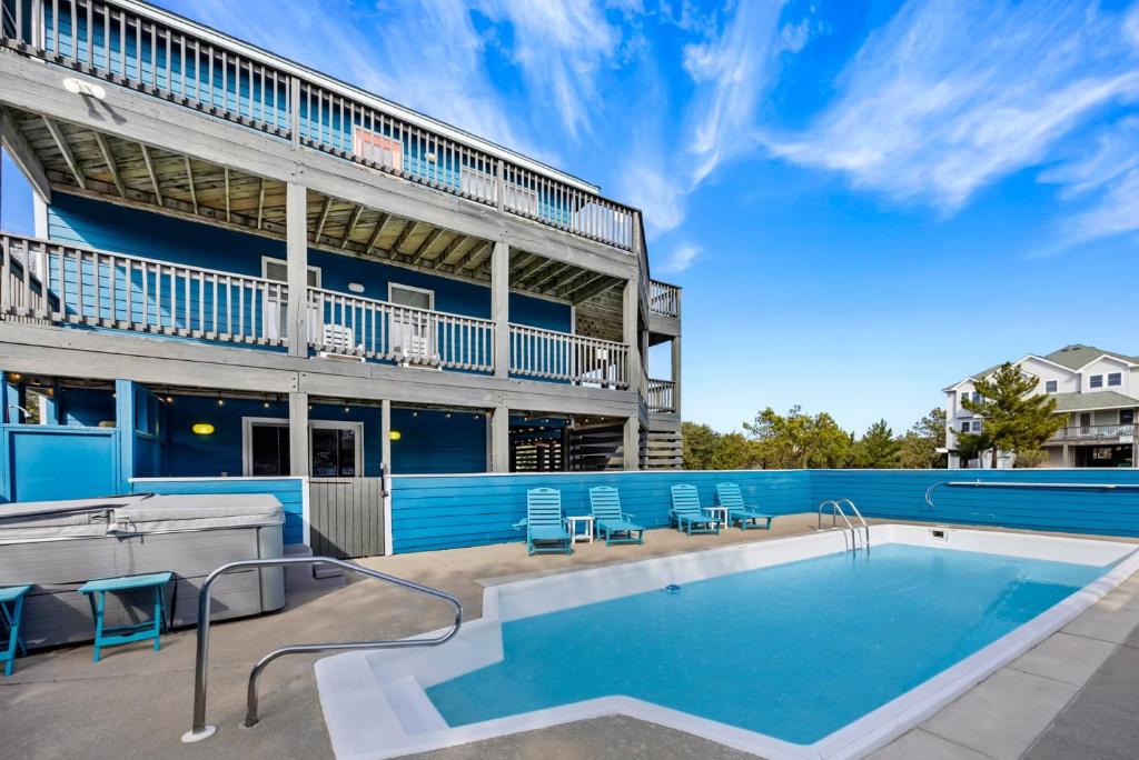 a swimming pool in front of a building at 1345 - Amarissa by the Sea in Corolla