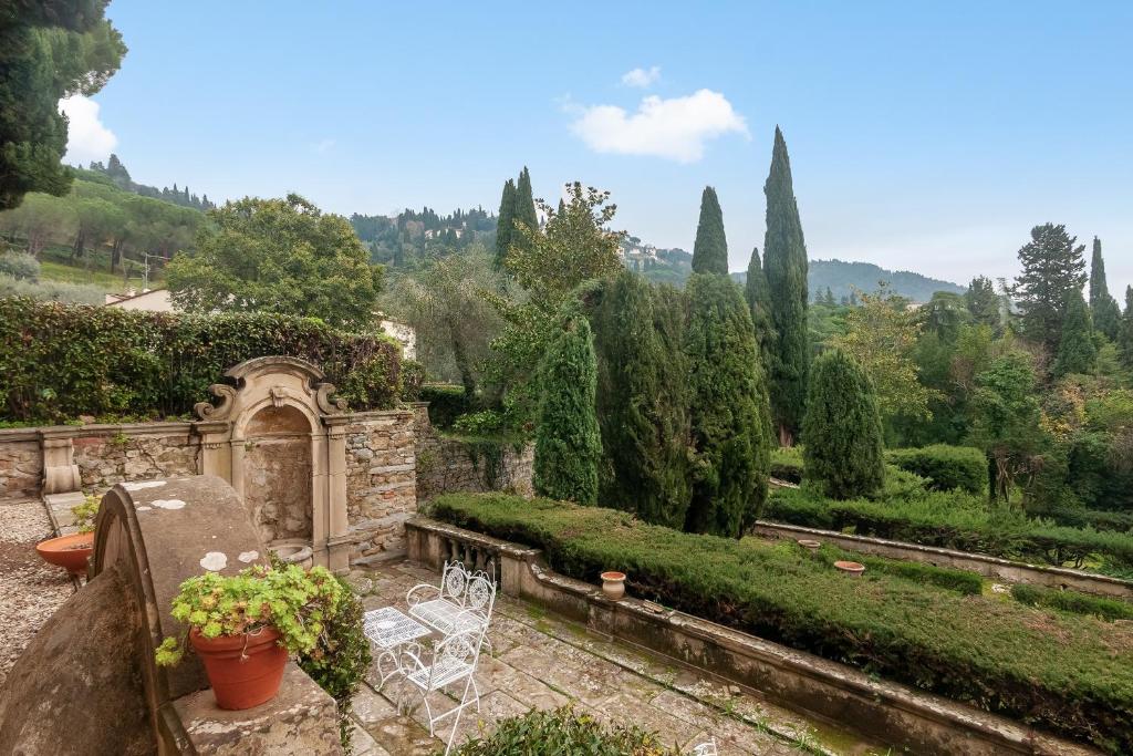 a view of a garden with chairs and trees at Villa Toscana a Fiesole in Florence