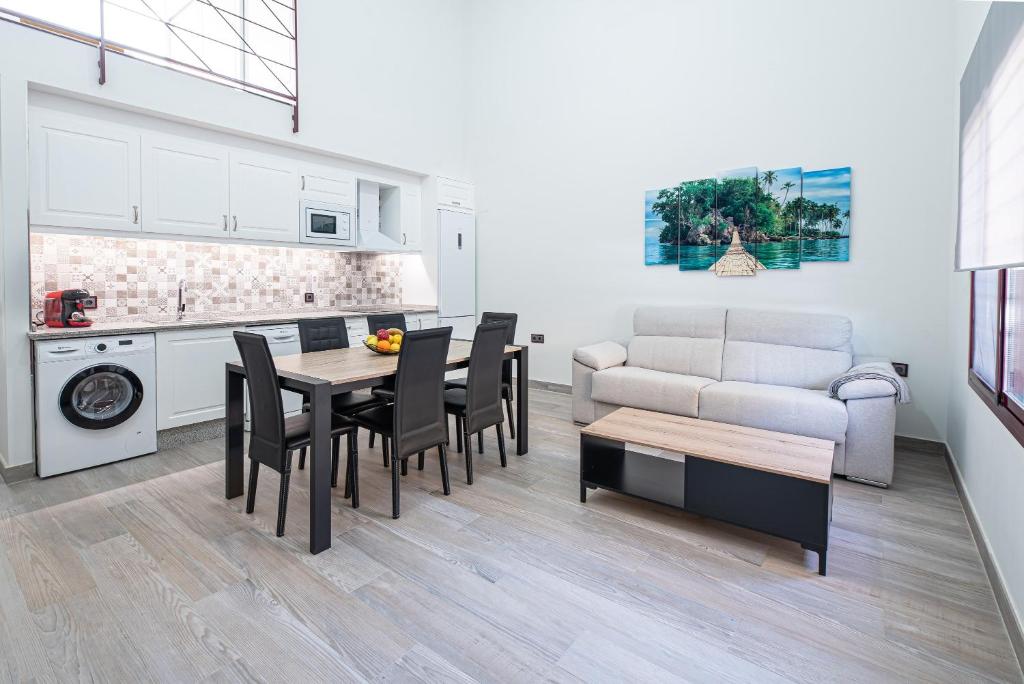 a kitchen and living room with a table and chairs at Ocean Suites A1 in Isla Cristina