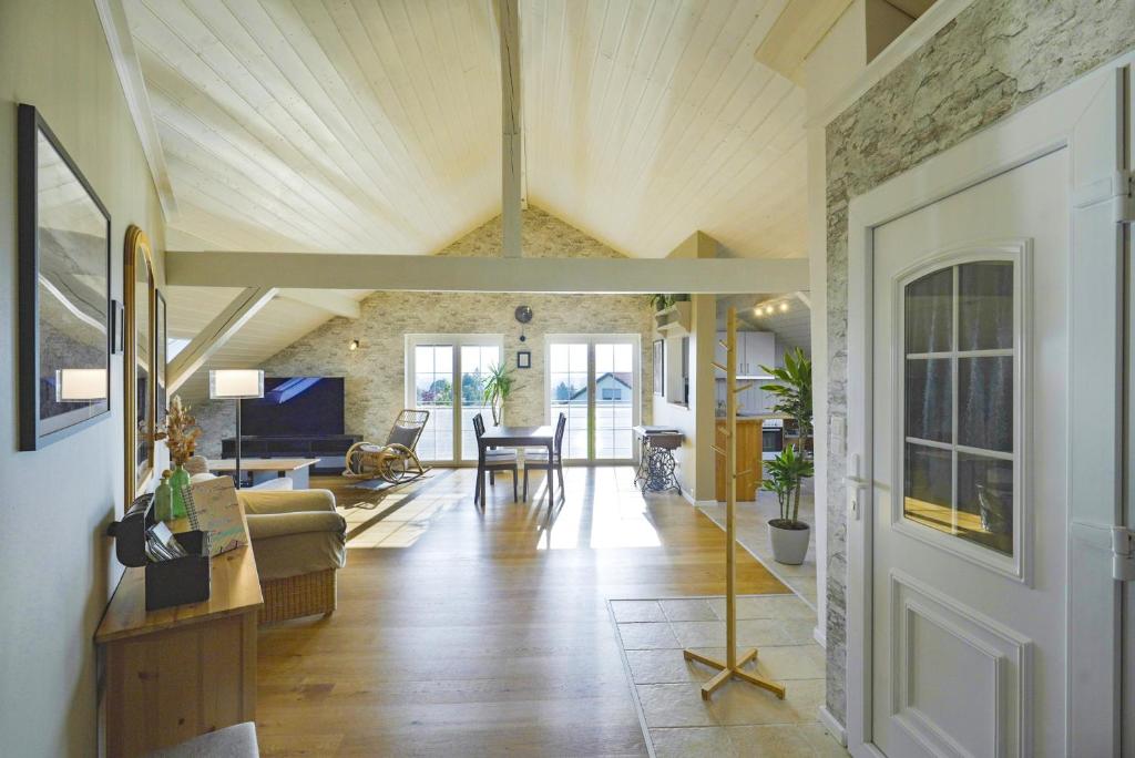 a living room with a stone wall and a ceiling at Happy Hugle Haus in Offenburg