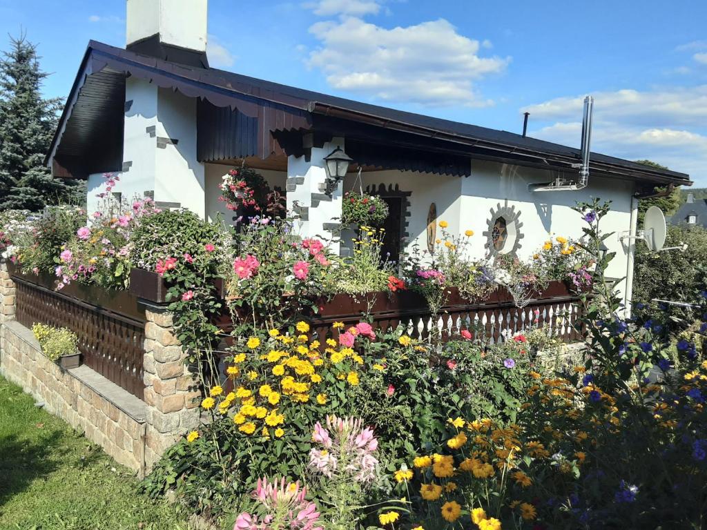 a flower garden in front of a house at Ferienhaus Werner in Neustadt