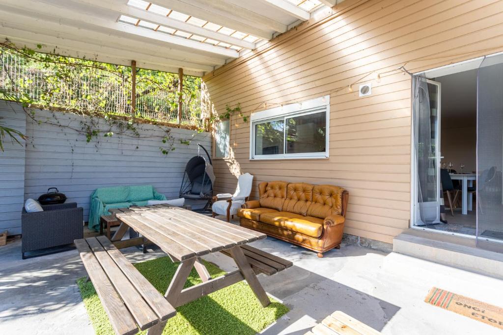 a patio with a couch and a table at Gîte Axeri Xilo in Saint-Martin-dʼArrossa