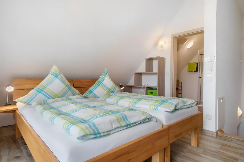 a bedroom with a large white bed with pillows at Waldsuite in Friedrichshafen