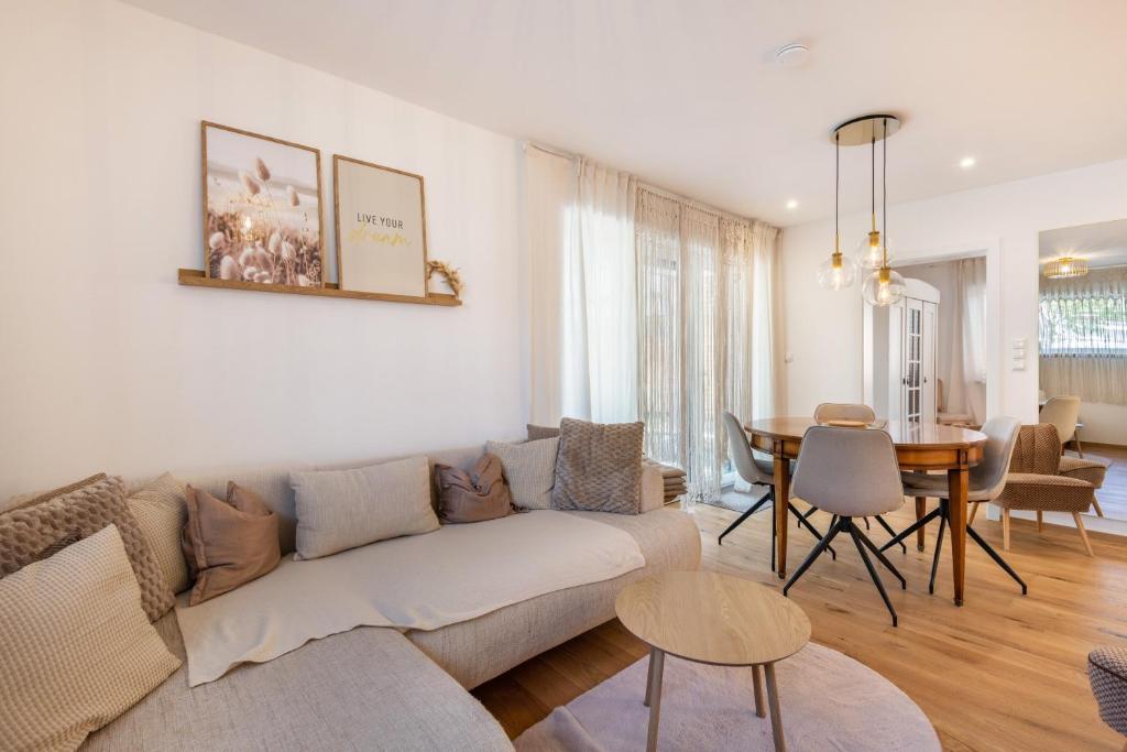 a living room with a couch and a table at bei Thérèse - Erdgeschoss in Miltach