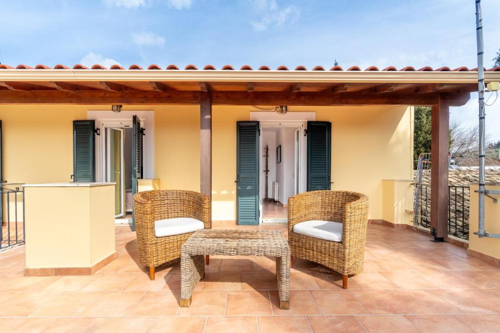 a patio with wicker chairs and a table at Ilios Country house in Arillas