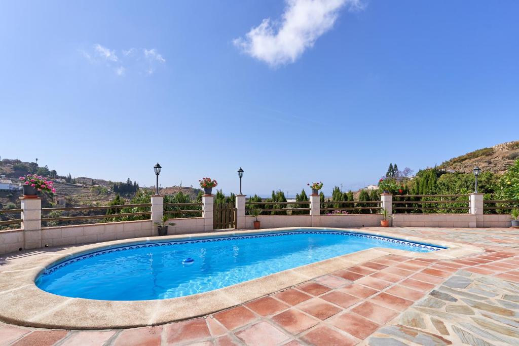 a swimming pool in the middle of a patio at Casa Torre del Manzano in Torrox