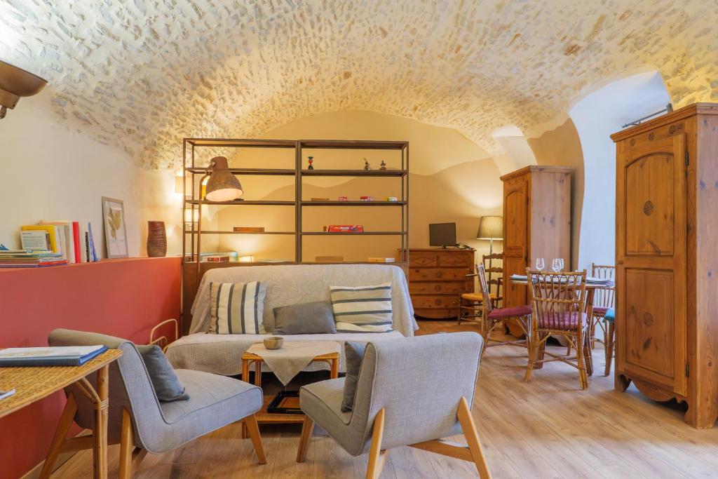 a bedroom with a bed and a table and chairs at Studio De Caractère Classé 3 in Les Vans