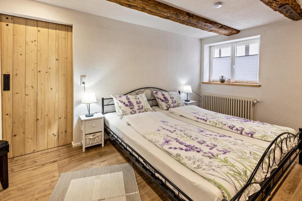 a bedroom with a large bed and a window at Schmid am See in Gaienhofen