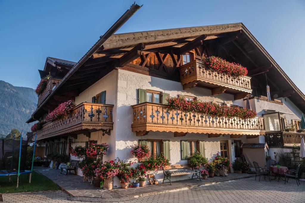 a large building with balconies and flowers on it at Ferienwohnung Waxenstein in Grainau