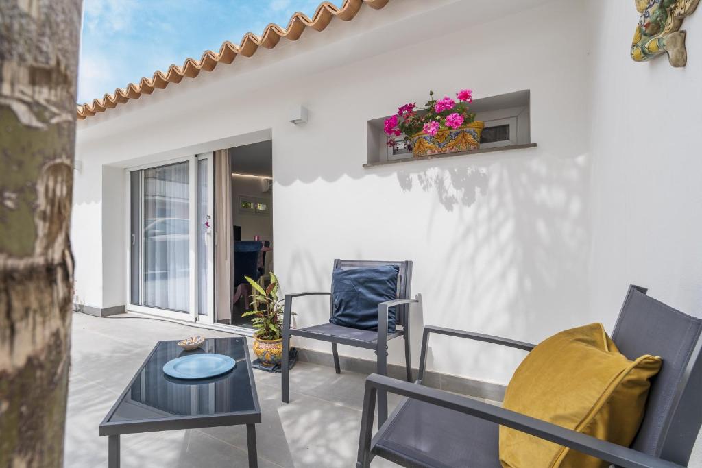 a patio with two chairs and a table at La casa di Susy in Avola