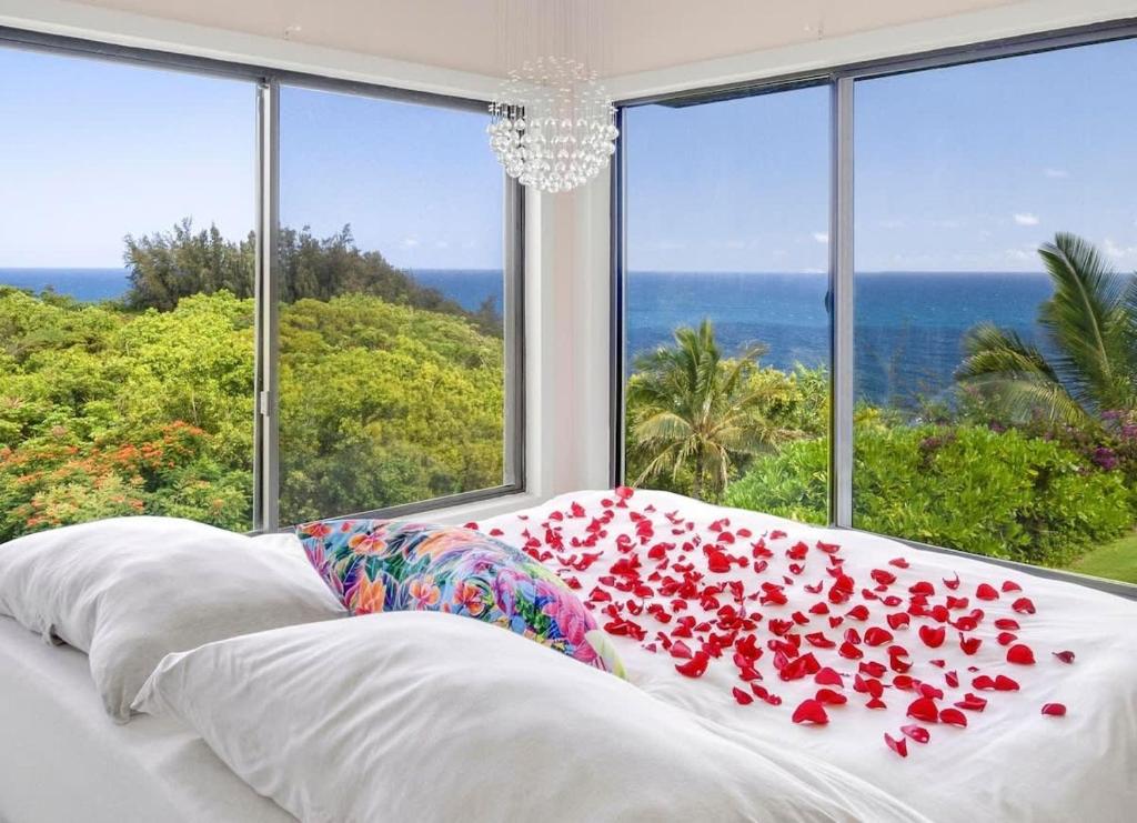 a bed with a bunch of red roses on it at Sealodge A2 Romantic Ocean View Oasis with Pool in Princeville