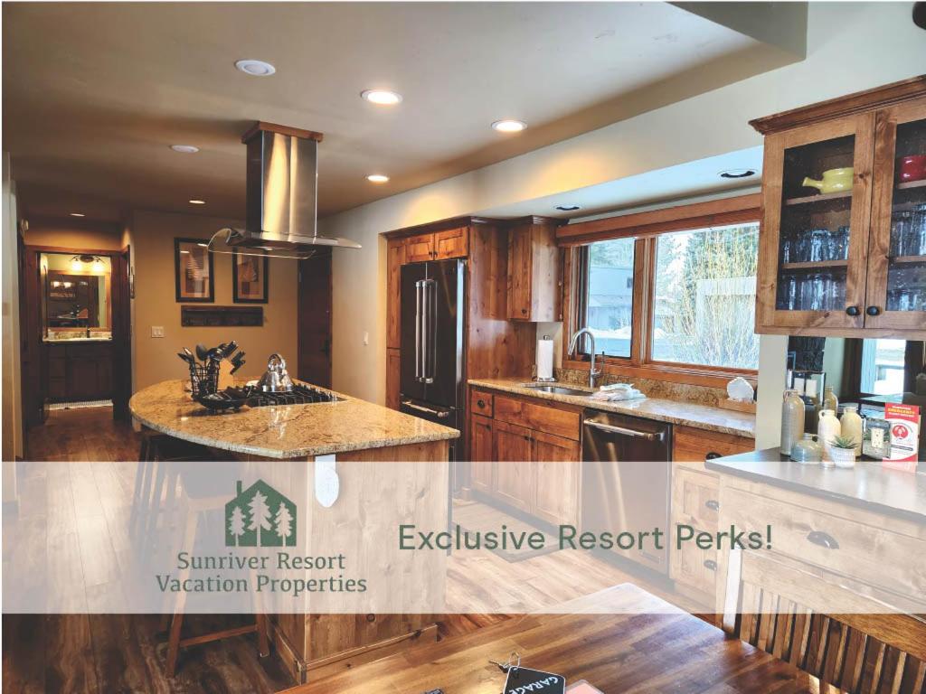 a kitchen with a sink and a refrigerator at 32 Meadow House in Sunriver