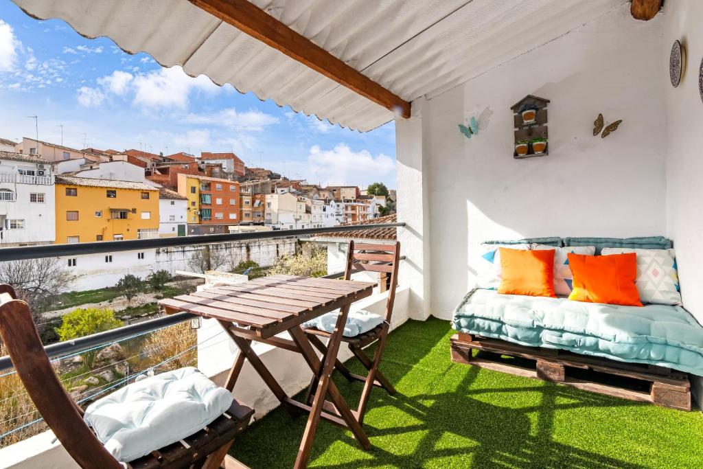 a balcony with a table and chairs and a view at Tío Salvador in Bolbaite