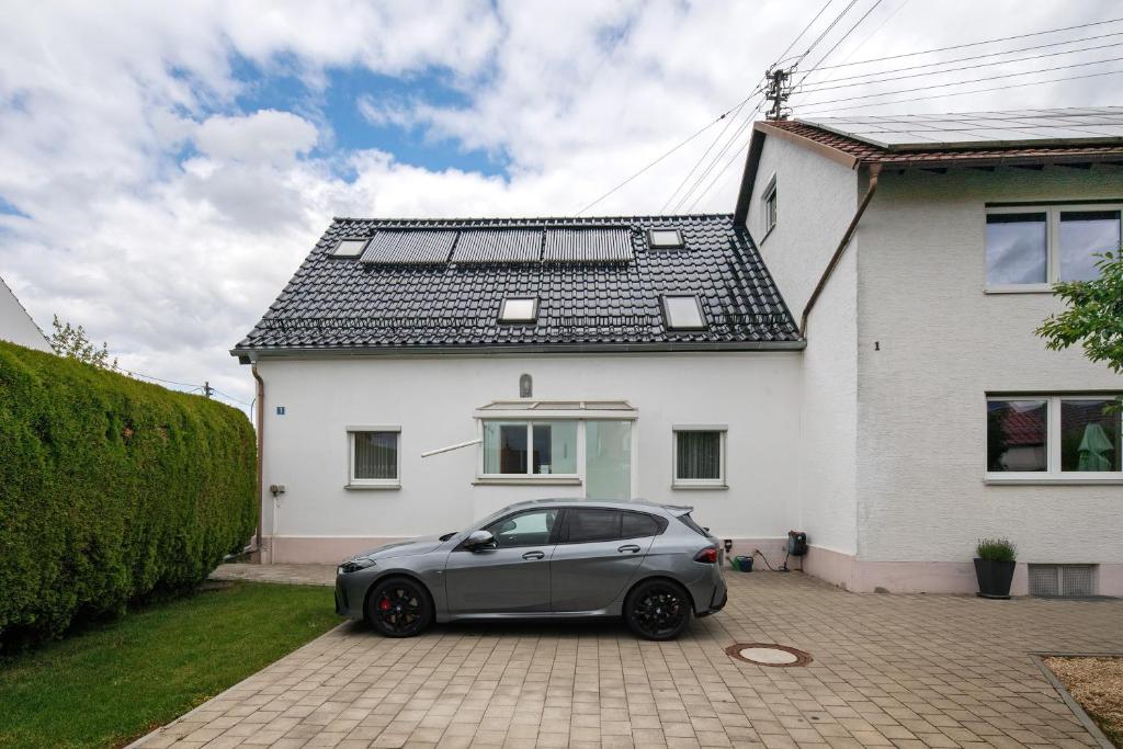 a silver car parked in front of a white house at Haus Steinheim in Dillingen an der Donau