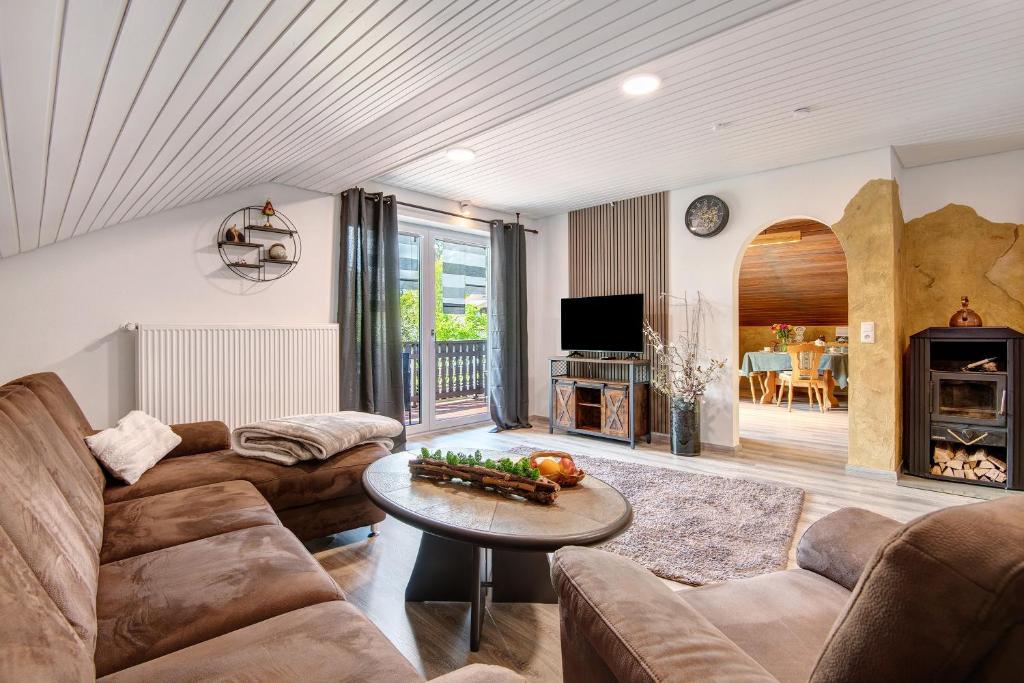 a living room with a couch and a table at Auenwald in Roding