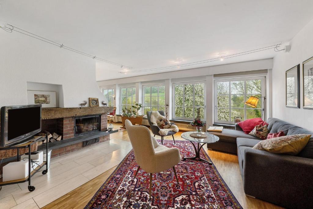 a living room with a fireplace and a tv at Auf Der Stadtmauer in Schmallenberg