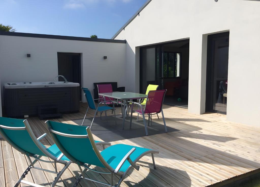 a patio with chairs and a table on a deck at Hâvre de Paix Perros in Perros-Guirec