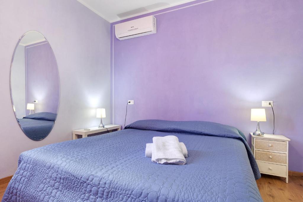 a blue bedroom with a bed and a mirror at Casabianca - The best for bikers in Finale Ligure