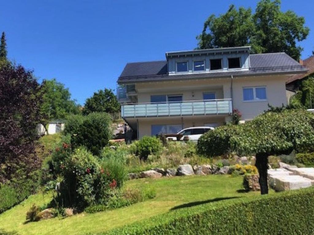 a house on a hill with a garden in front of it at Ferienwohnung Kist in Sasbachwalden