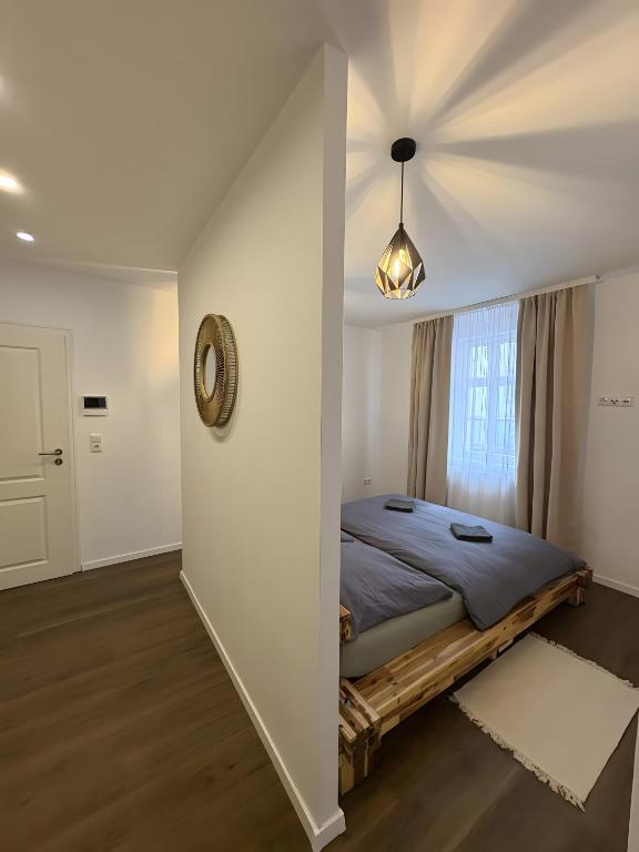 a bedroom with a bed and a window at C & D Wohnung I in Bad Kissingen