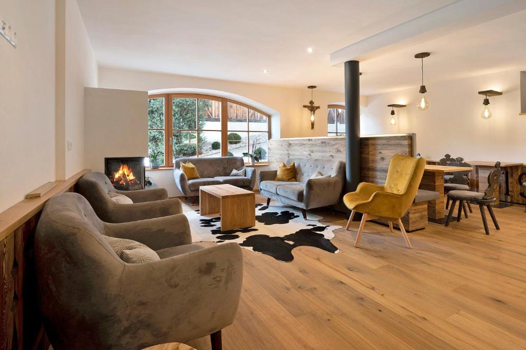 a living room with couches and a fireplace at Leierhof Wicky in Rodengo