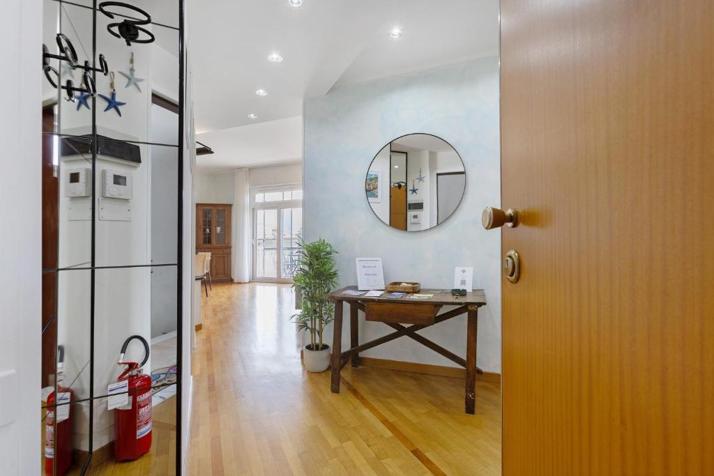a hallway with a table and a mirror on a wall at Casa vacanze Brezza di Levante in Sestri Levante