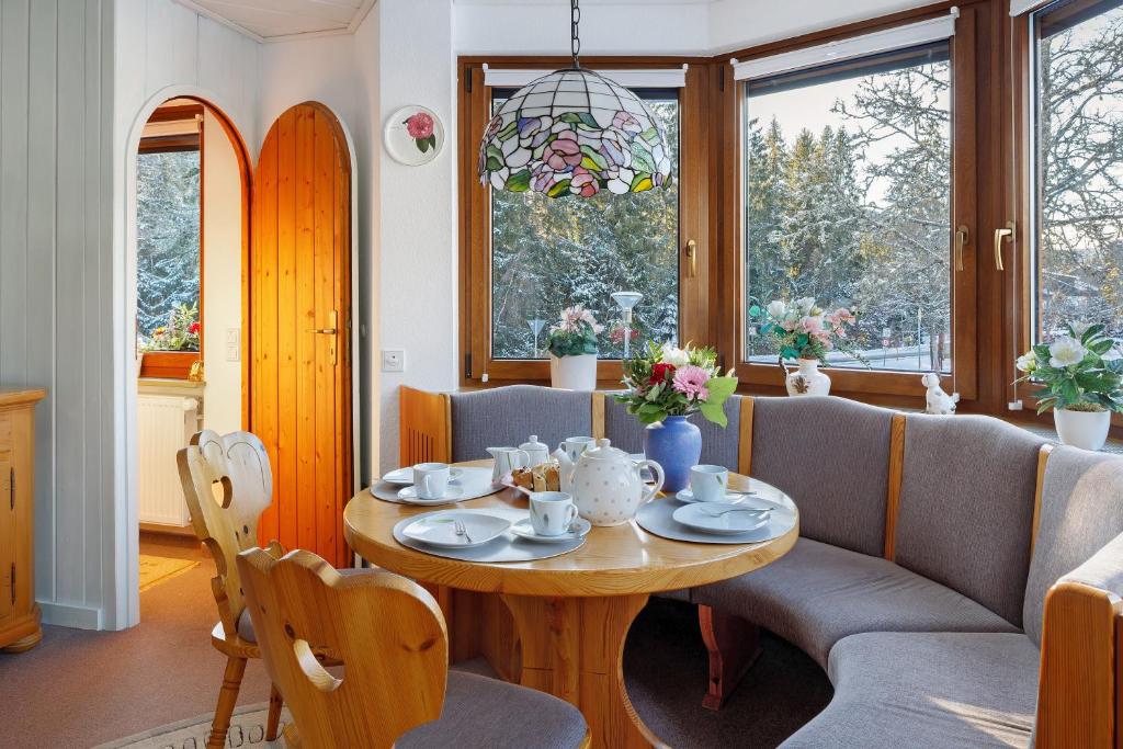 a dining room with a table and a couch at Oskar im Bärenhüsli in Titisee-Neustadt